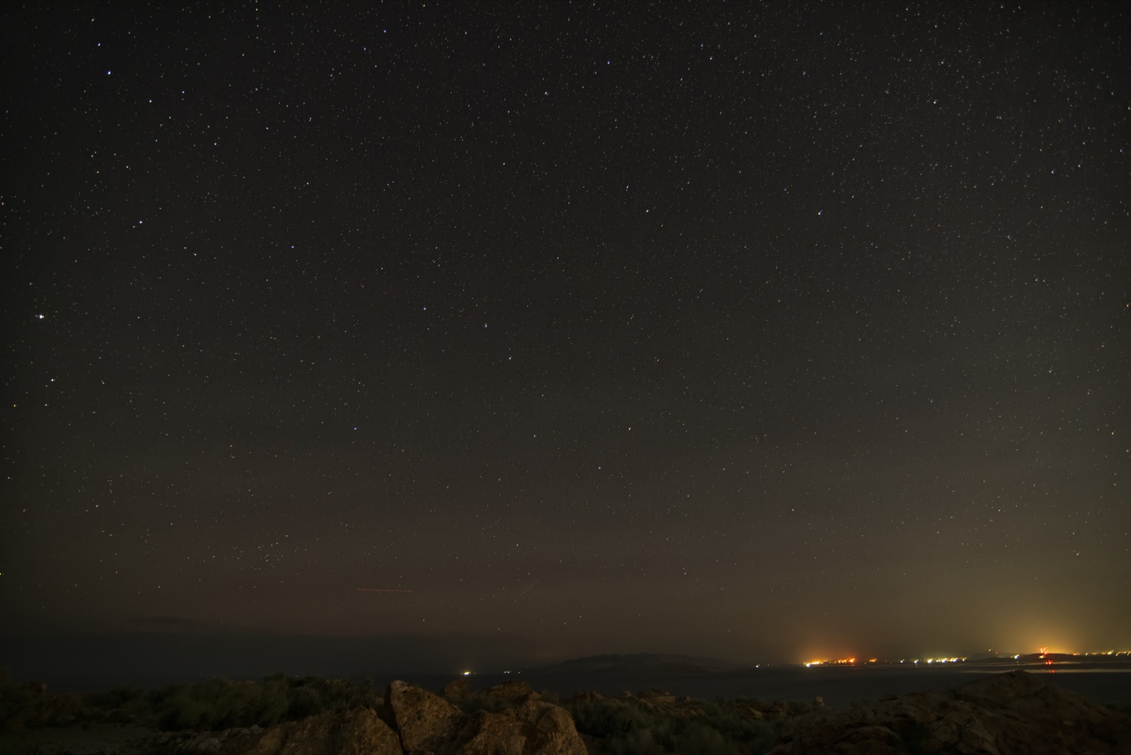Stars over the Great Salt Lake at Antelope Island State Park, with the Wasatch Front glow on the horizon